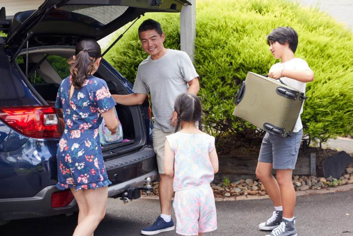 family packing their car for a holiday