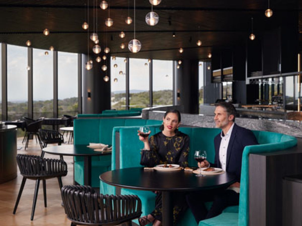 A couple enjoying dinner at Cape Schanck's Cape restaurant.