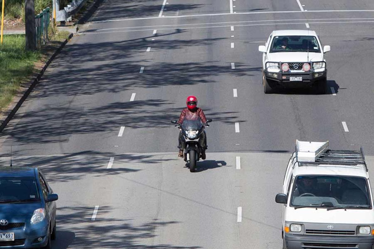Motorbike rider on the road among the traffic.