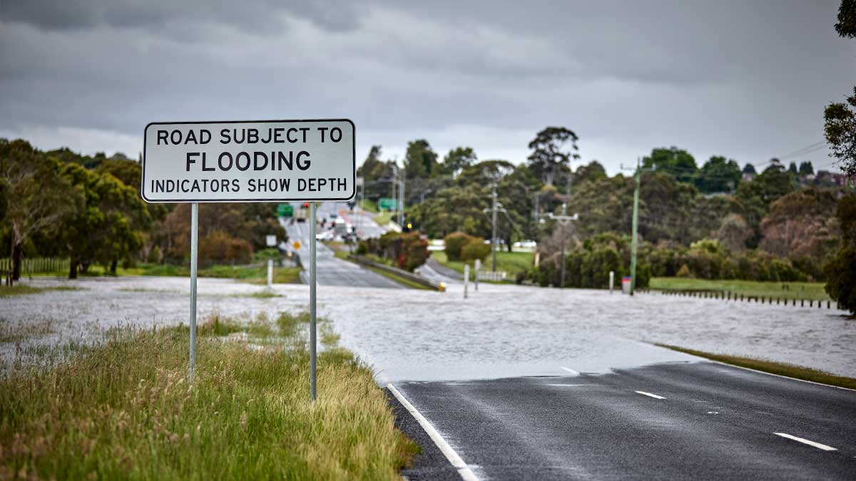 Flooded road with town in background