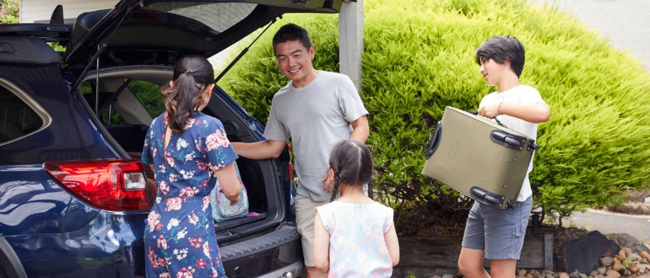 family packing their car for a holiday