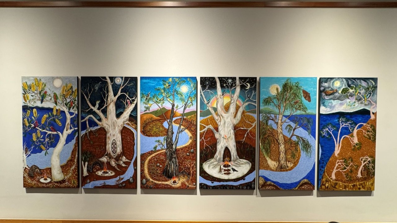 Six separate artworks on the wall depicting trees, birds and nature 