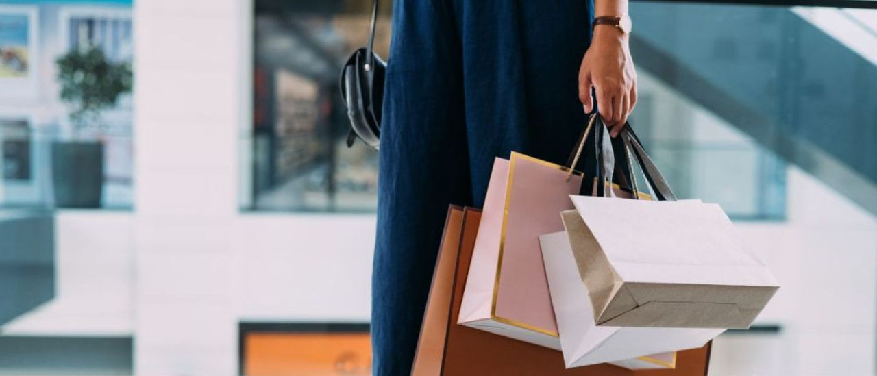 Someone holding multiple shopping bags