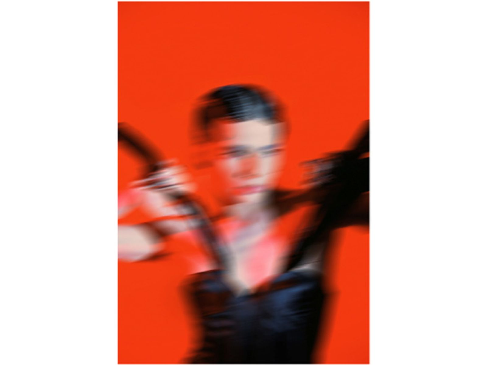 Photo of a blurred person on a red background.