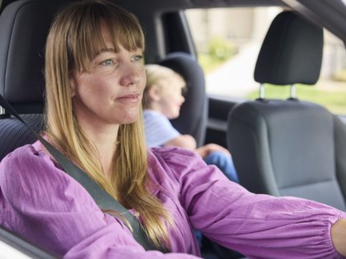 Female motorist driving with a seatbelt on