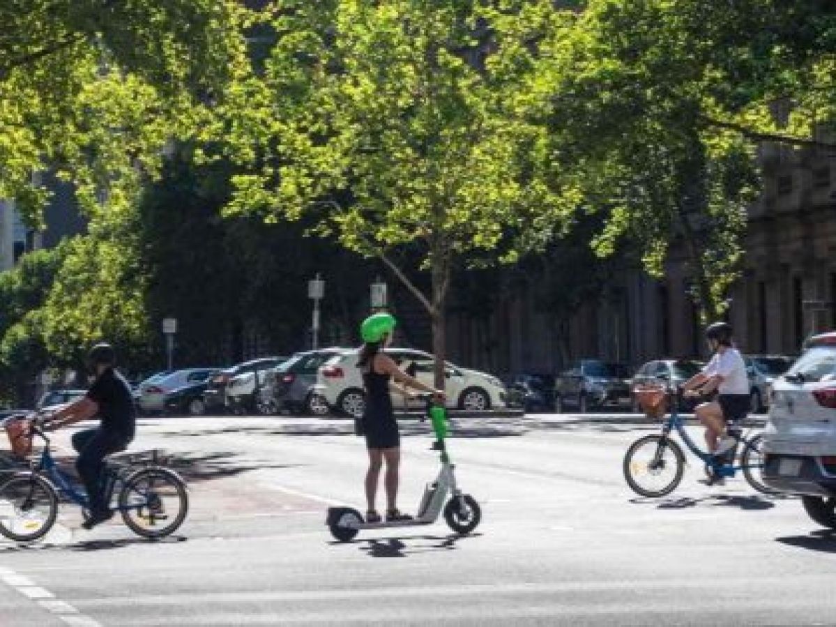 Woman riding an e-scooter in the middle of the road