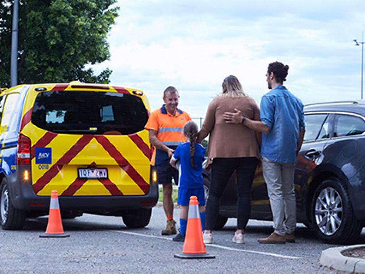 Emergency Roadside Assistance vehicle assisting family