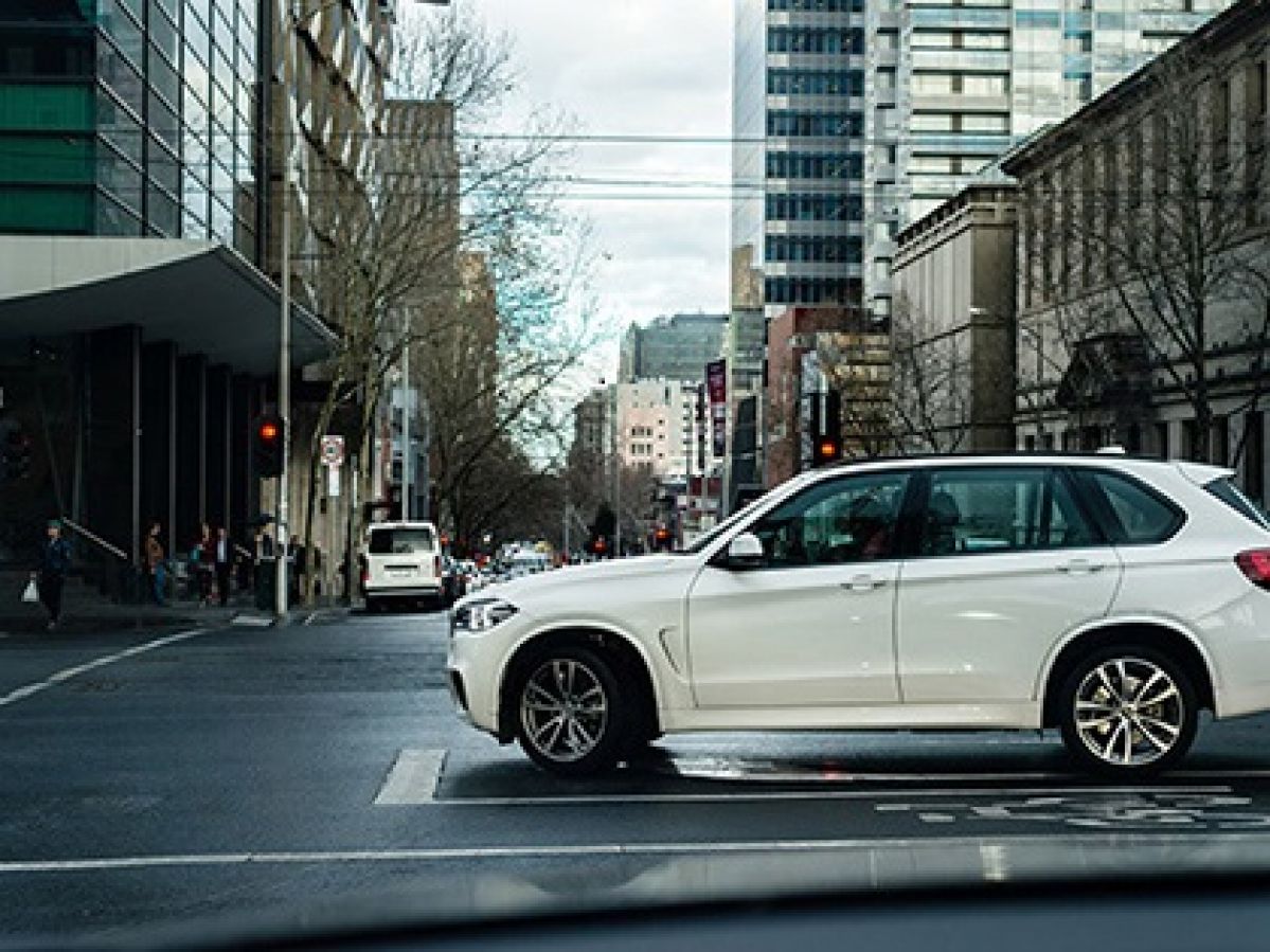 White SUV performing a hook turn in Melbourne, Australia.