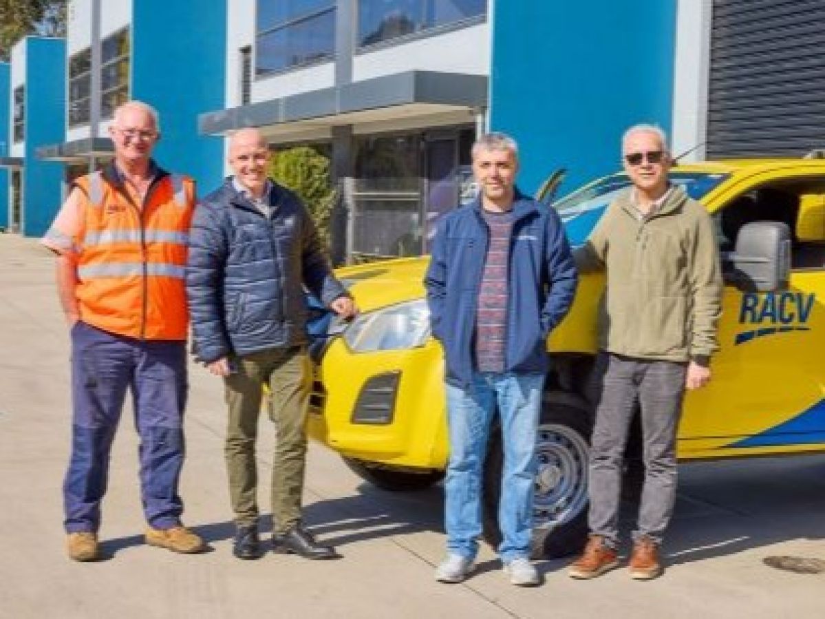 Four men standing in front of an RACV ERA patrol car.