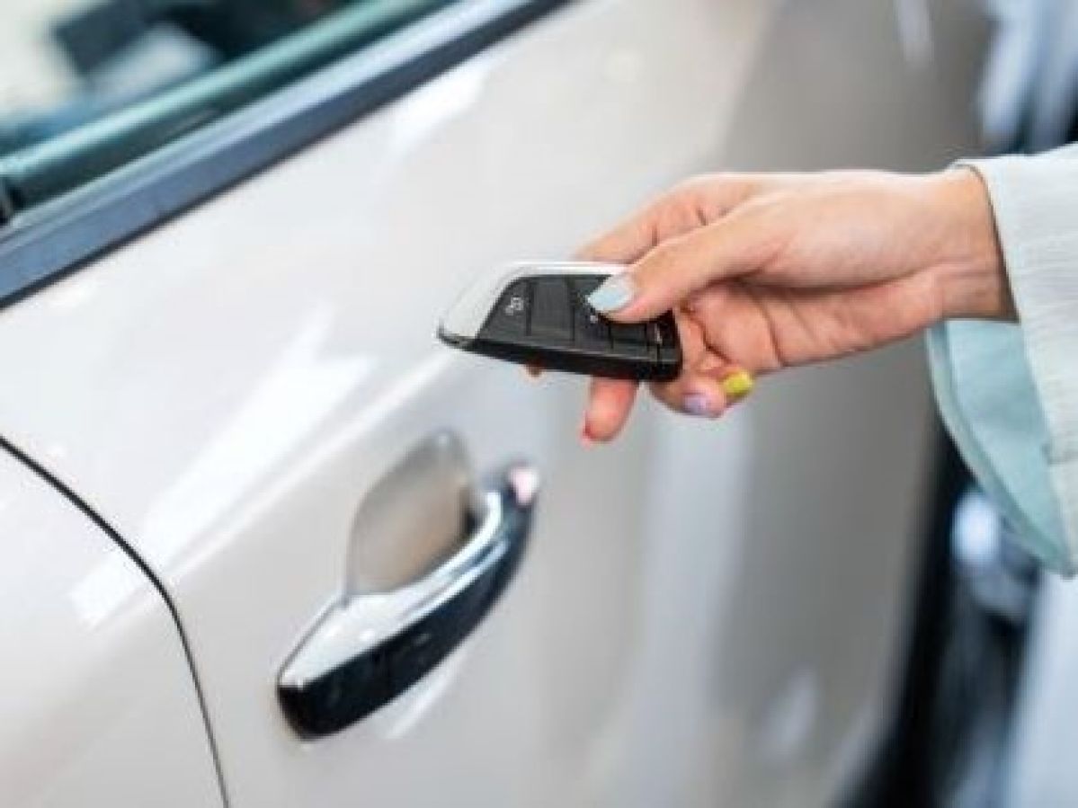 motorist uses key to enter vehicle