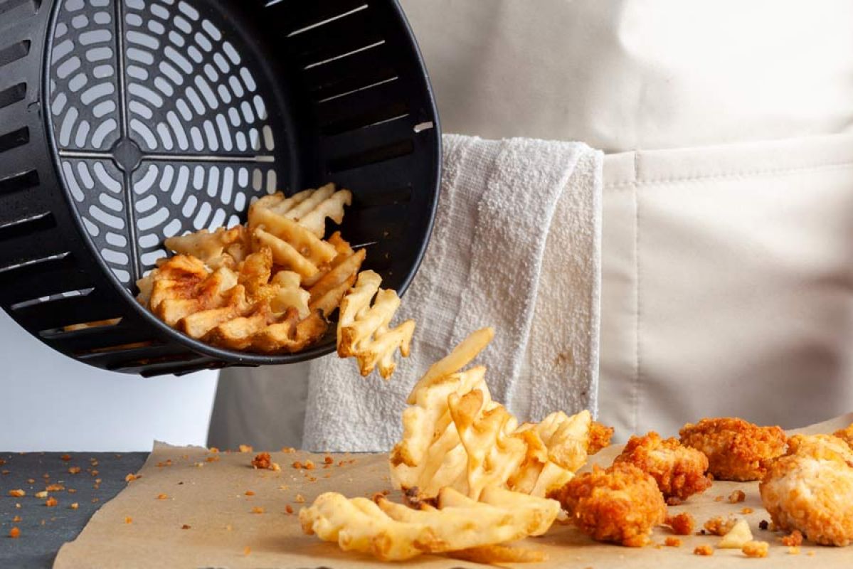 air fryer basket full of cooked potato