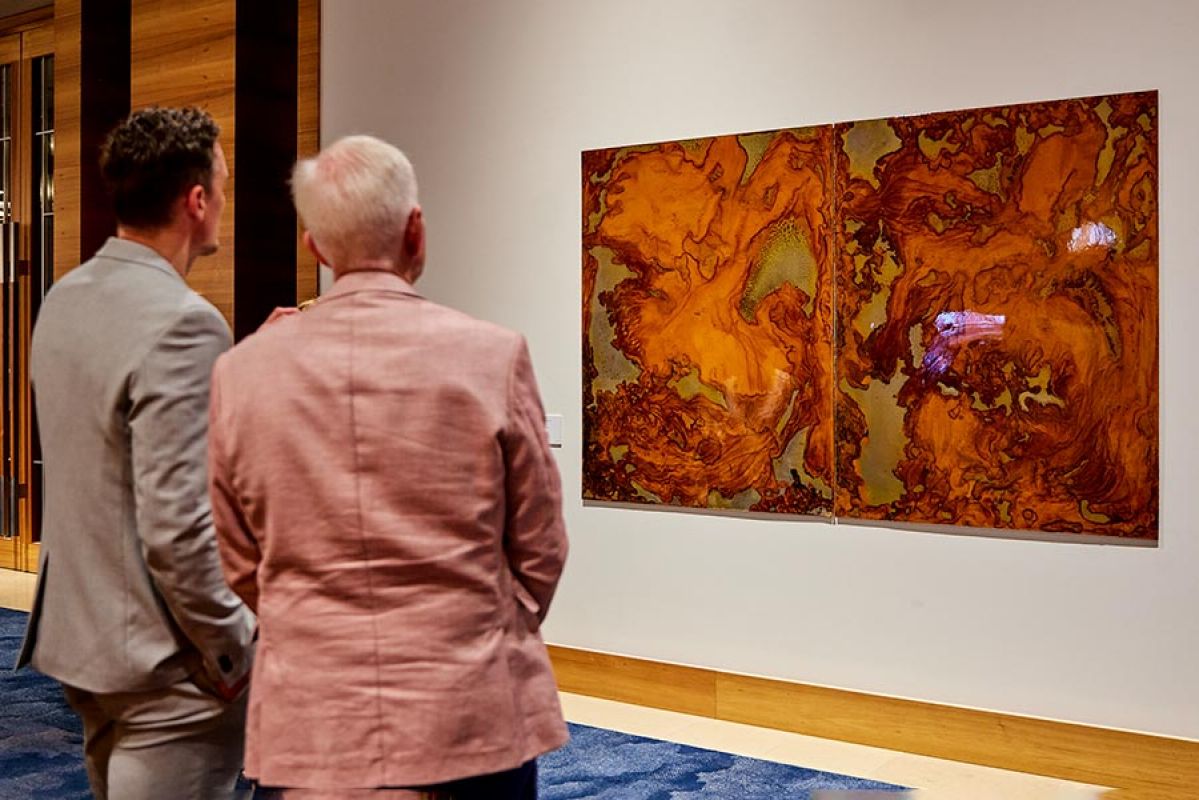 two men observing art in RACV Club