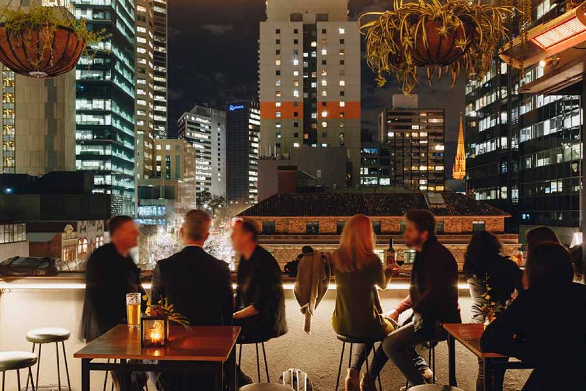 People enjoying a drink at the Bomba rooftop bar in Melbourne CBD