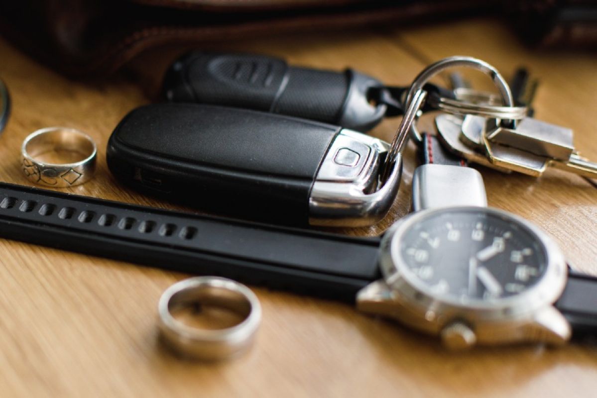 collection of easily stolen items: a watch, car keys, rings and a bangle