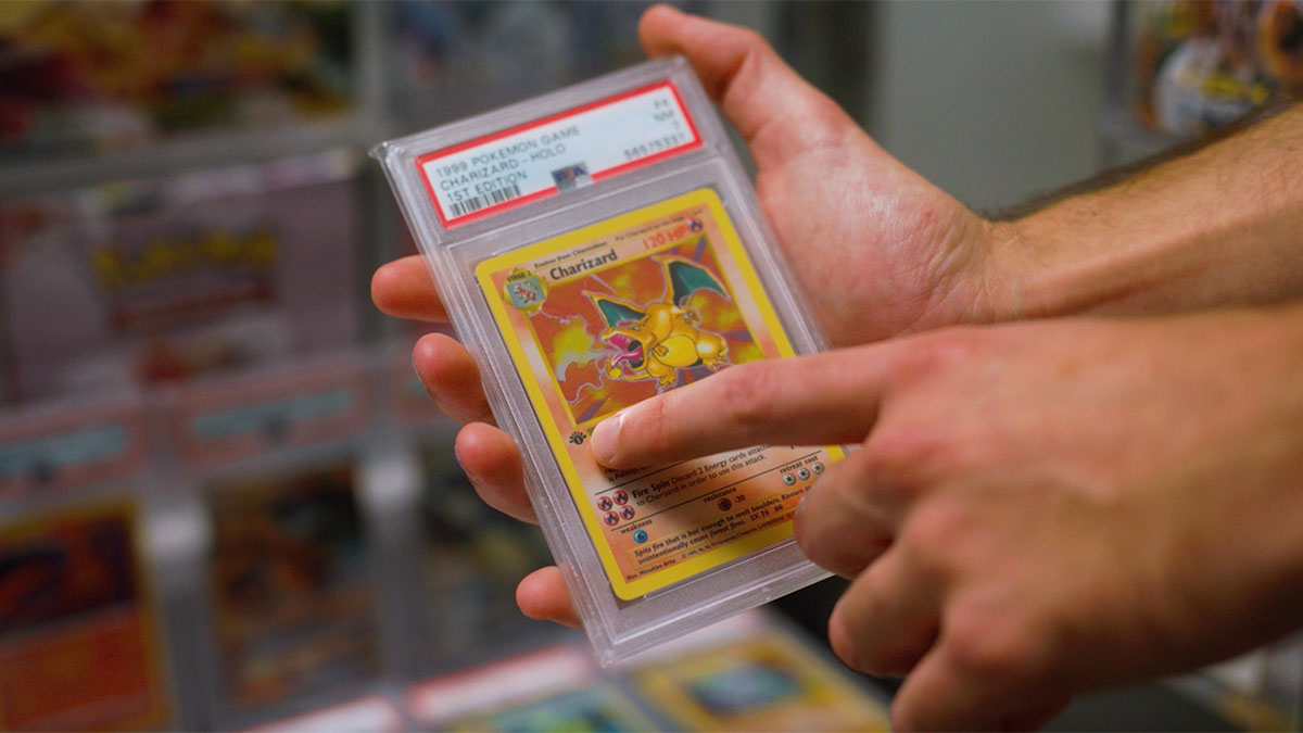 man holding Pokemon cards