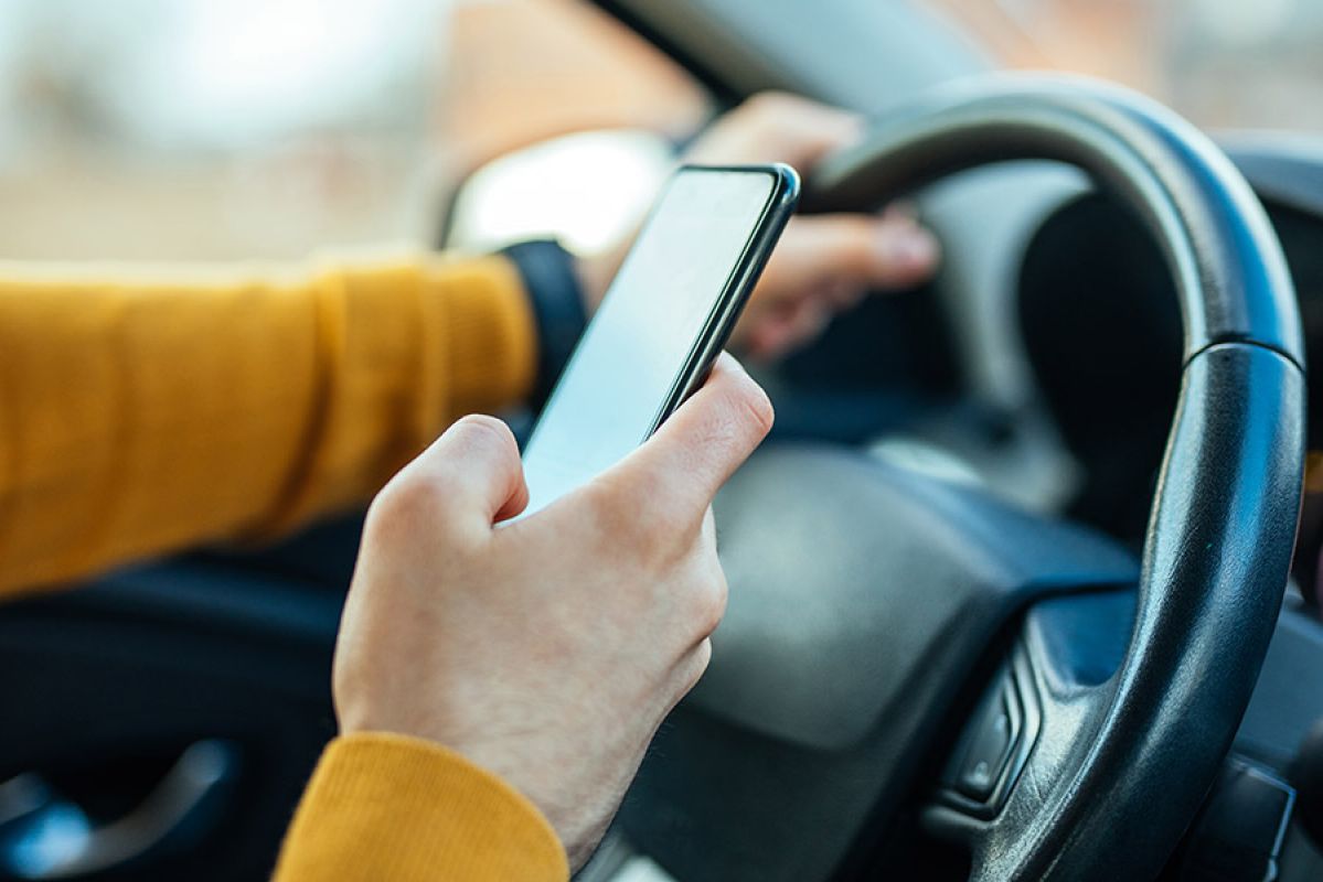 A person using their phone while driving