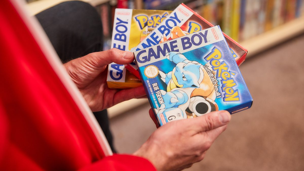 man holding Pokemon games