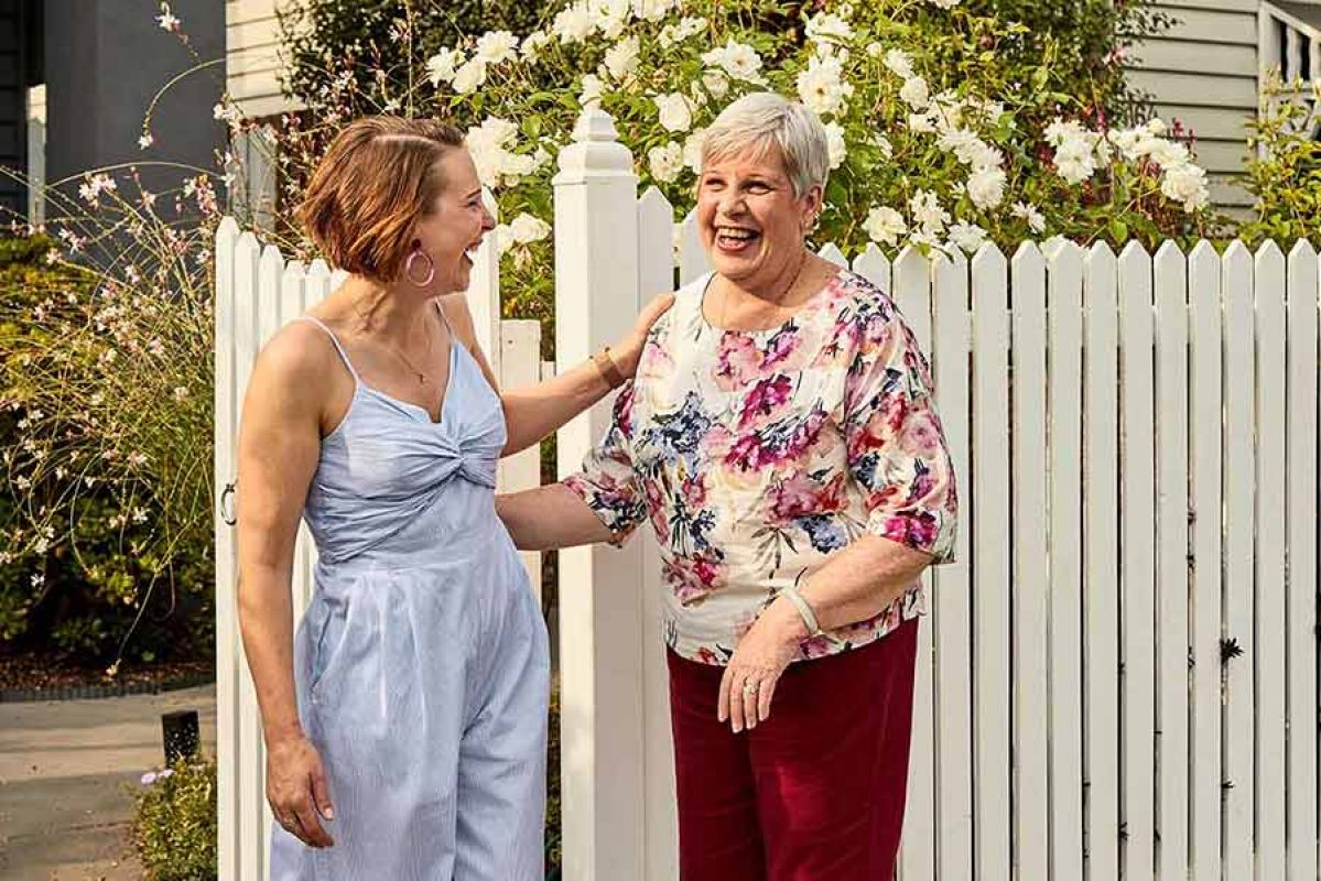Neighbours chatting over front fence
