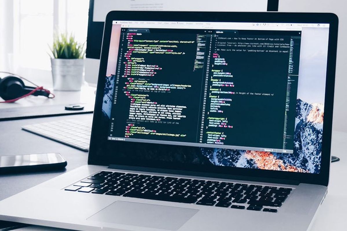 laptop computer on desk with coding