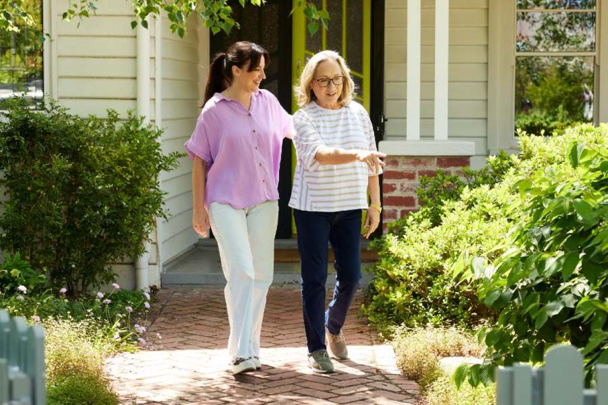 two women in garden outside house