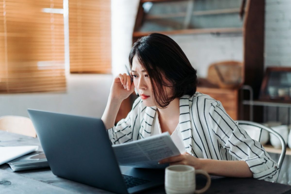 young woman looking at laptop