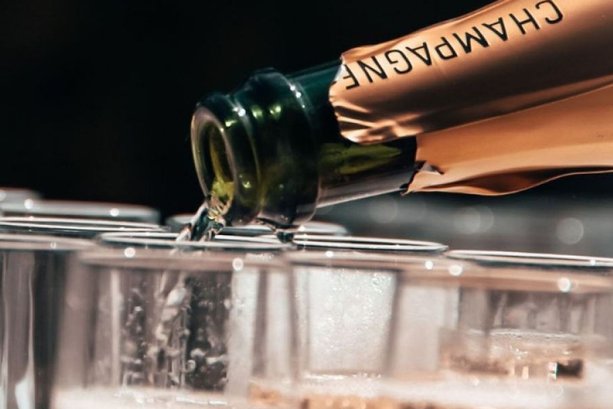 champagne being poured into flute glasses