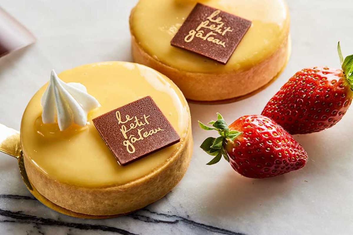 two lemon tarts and two strawberries 