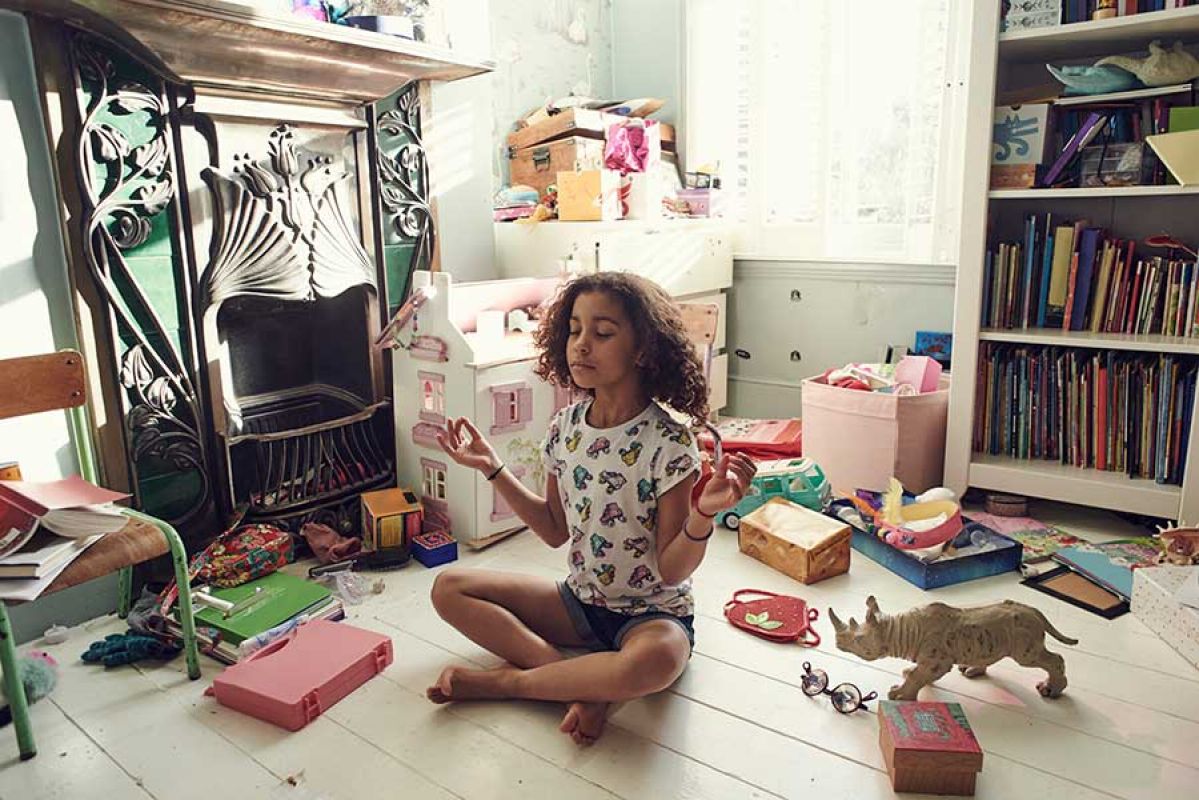 young girl doing yoga in bedroom