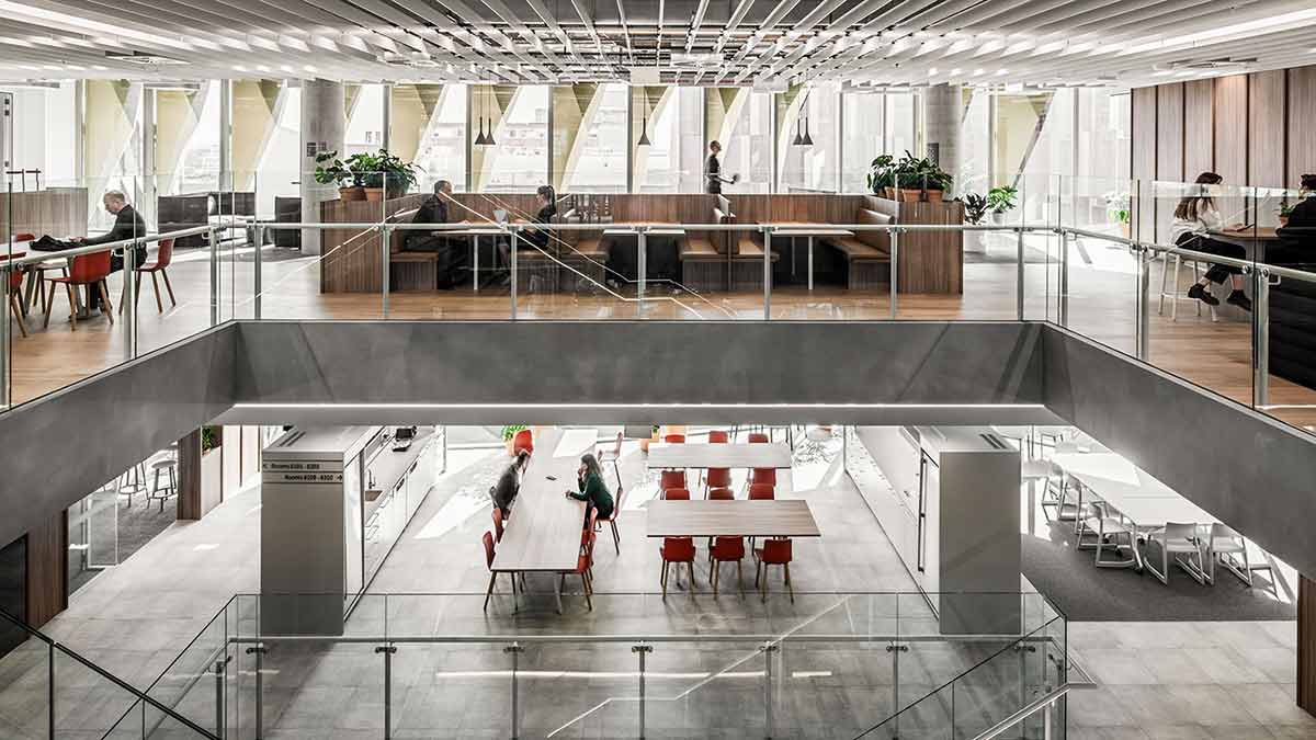 View of Melbourne University's 'Melbourne Connect' from the second floor staircase: a generous meeting and event space with people collaborating