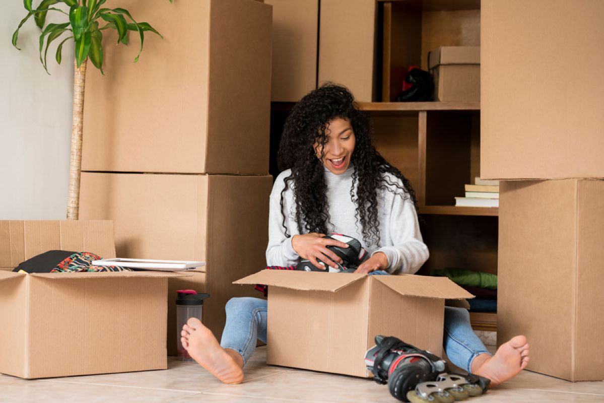 Woman unpacking moving boxes