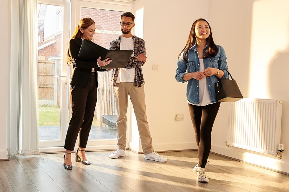 couple looking at home with agent