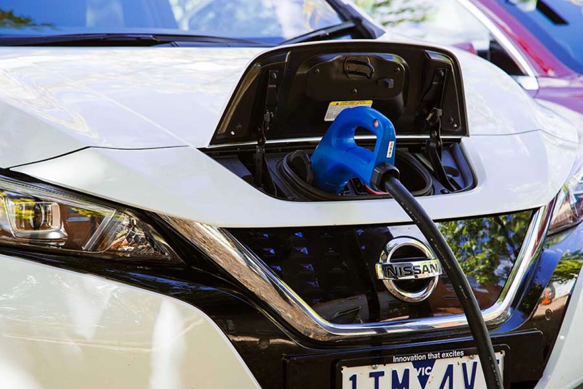 A white Nissan Leaf EV being charged using bi-directional charging