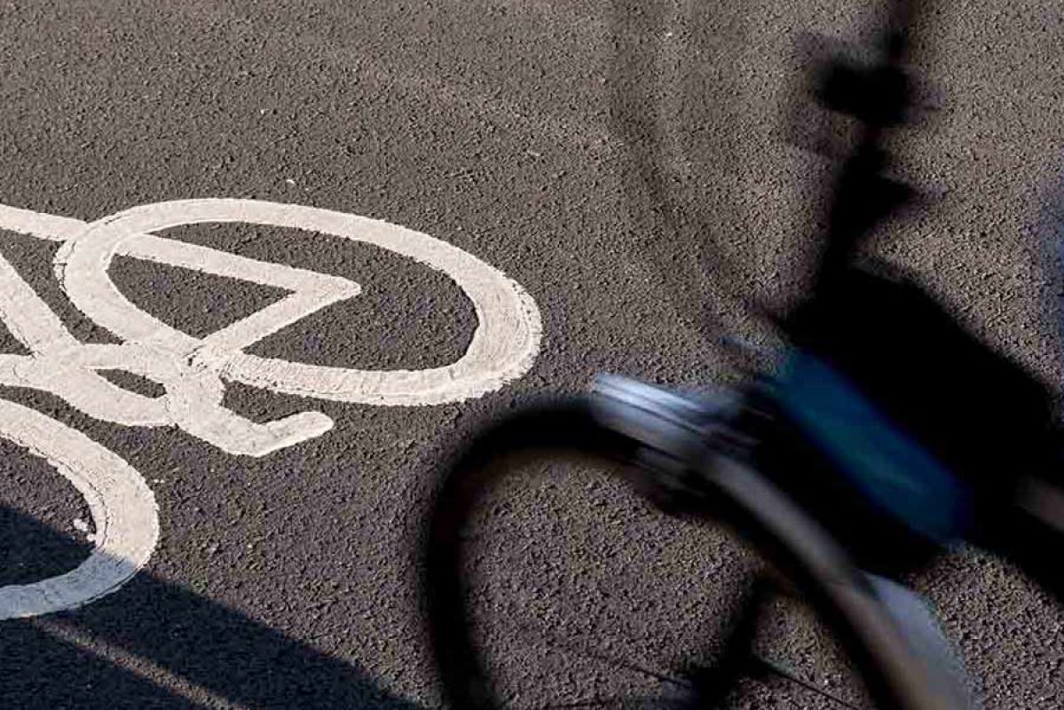 Bike going fast along bicycle lane on road.