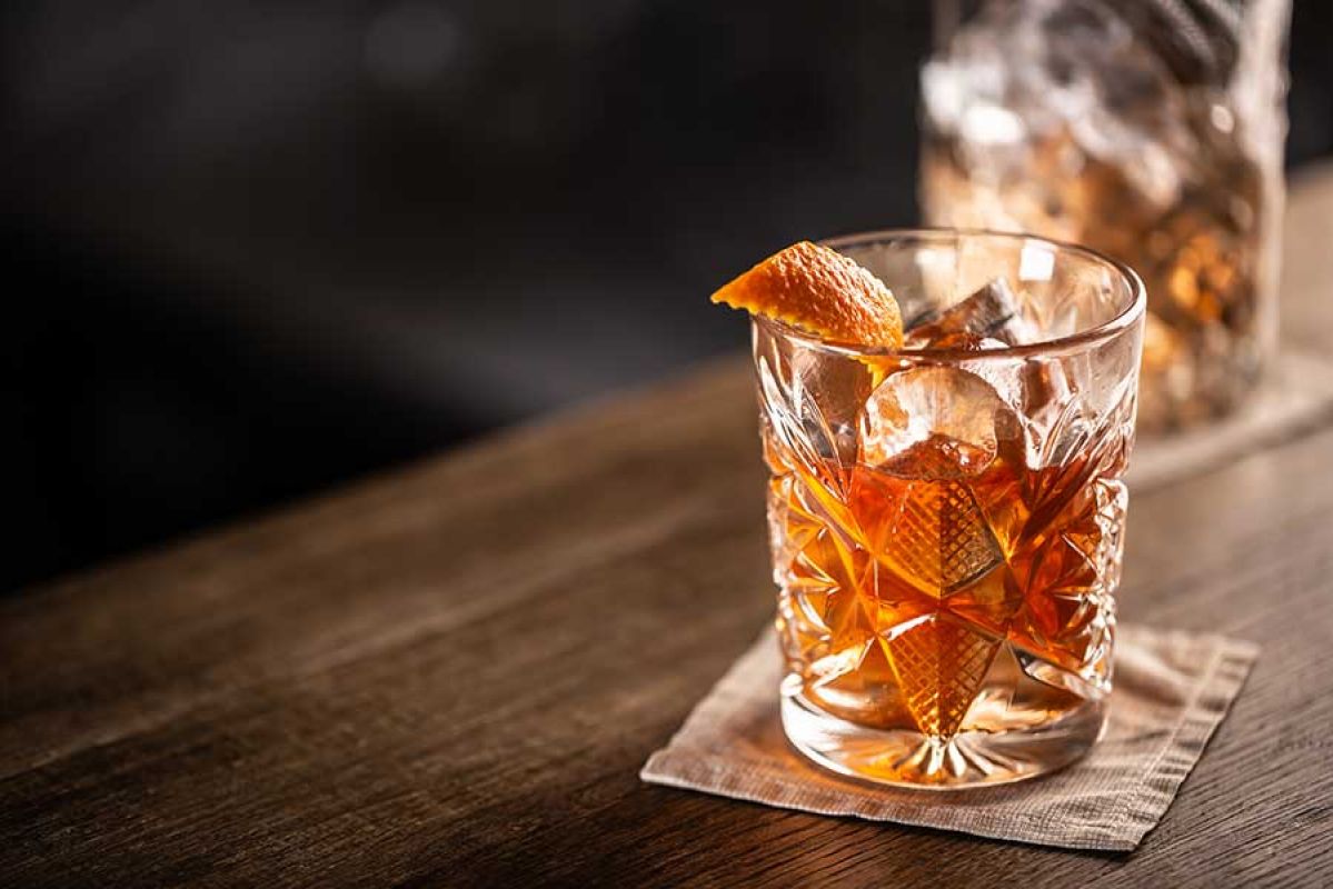 Rum cocktail in crystal glass with orange peel garnish. 