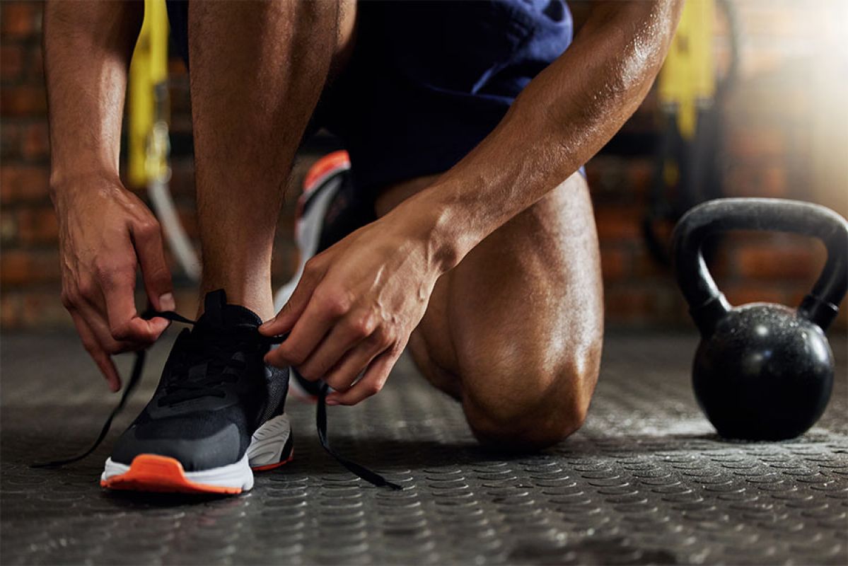 Man exercising with a dumbbell set