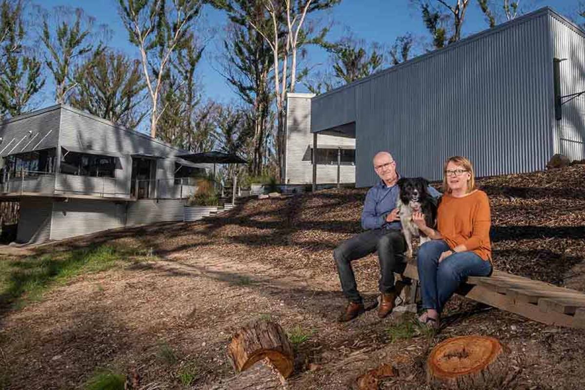 Couple sitting in front of bushfire-ready home