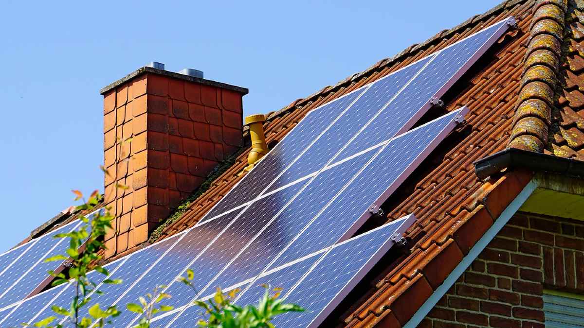 Solar panels on roof next to a chimney