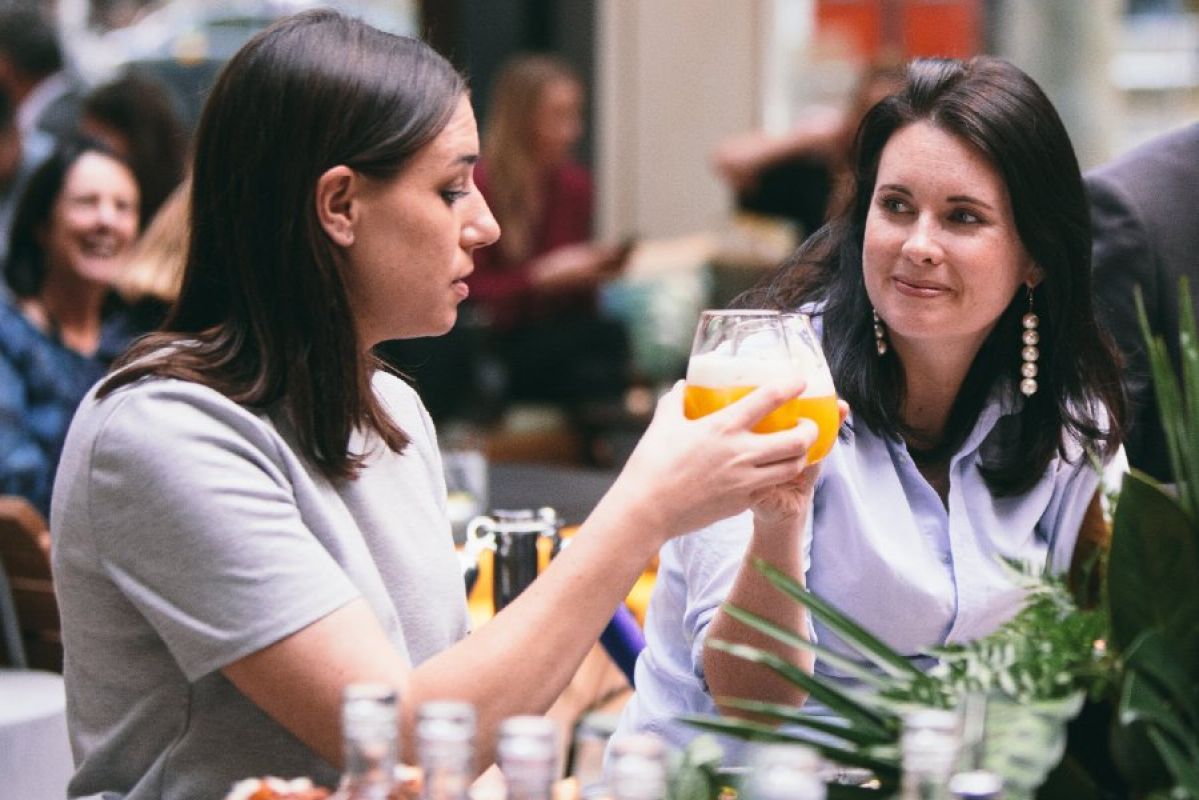 two women talking over drinks