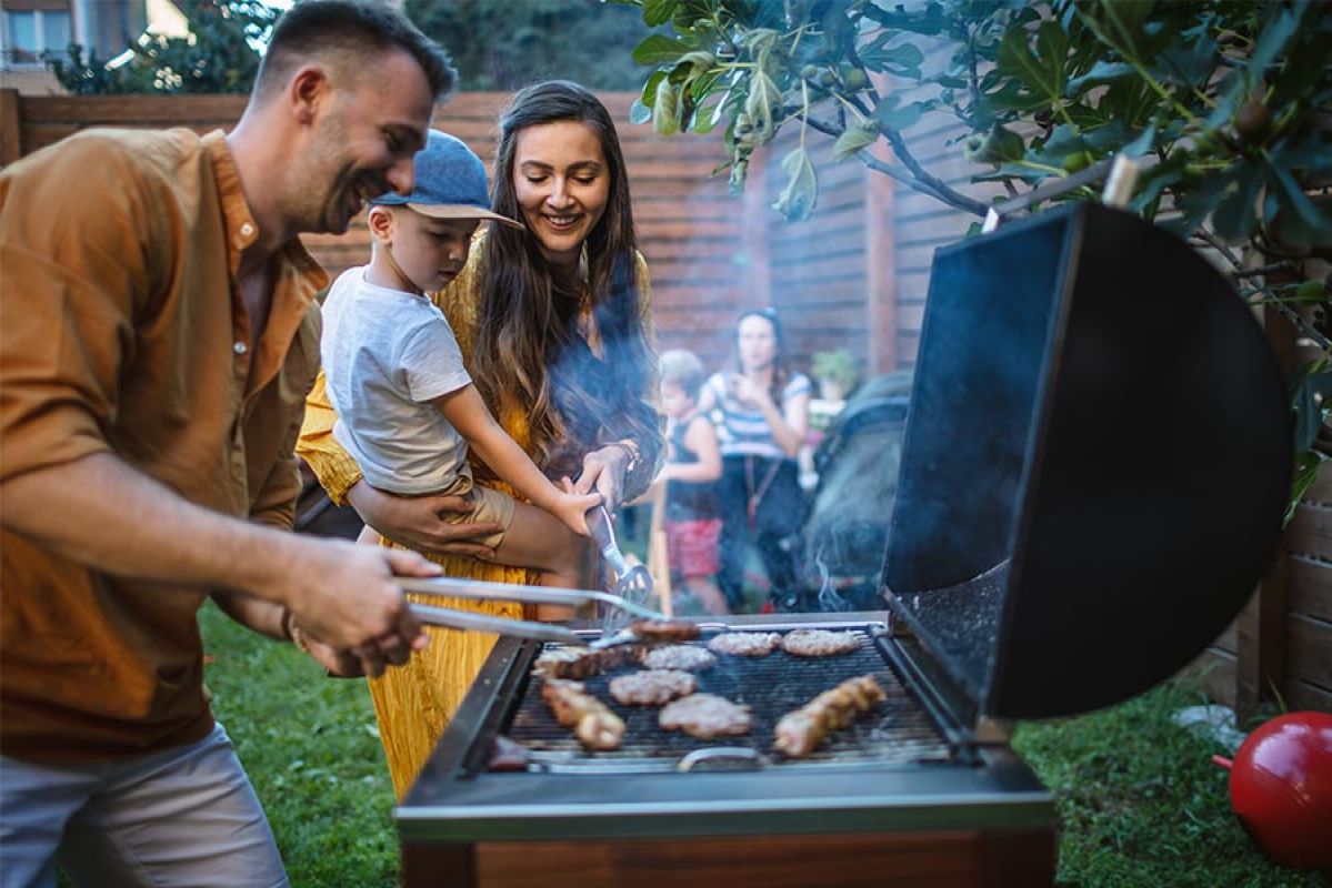 Family cooking and enjoying a summer BBQ