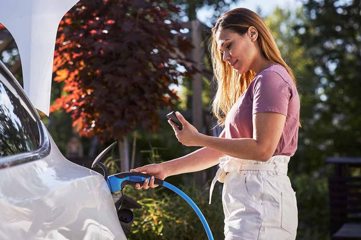 woman charging ev