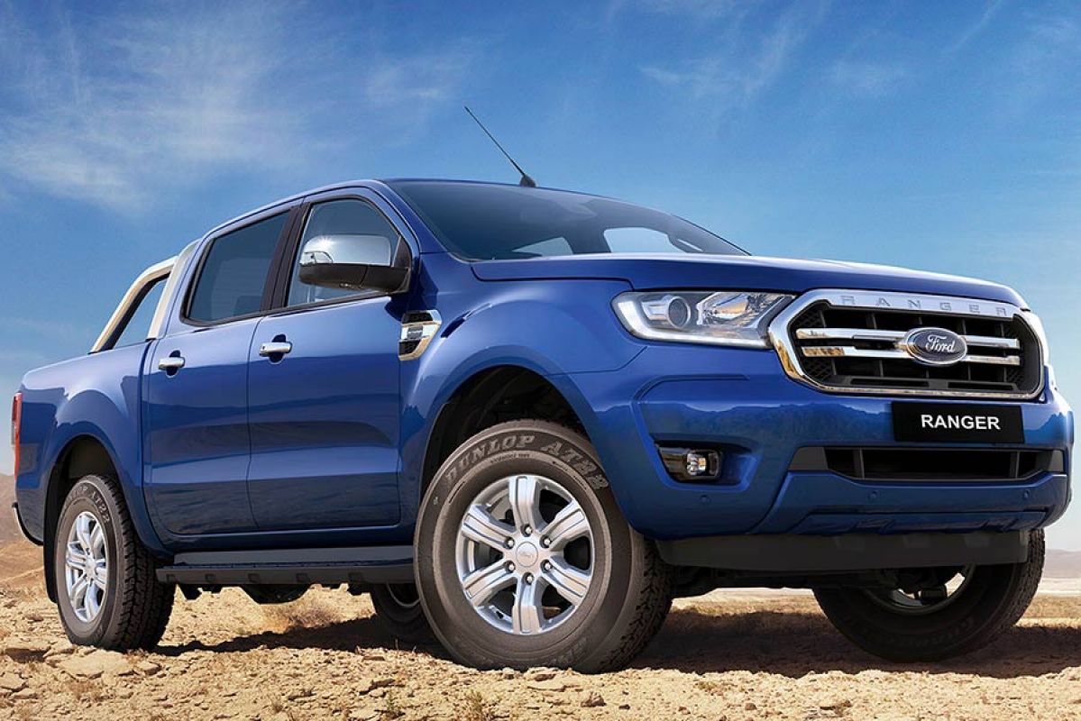 blue ford ranger parked on dirt
