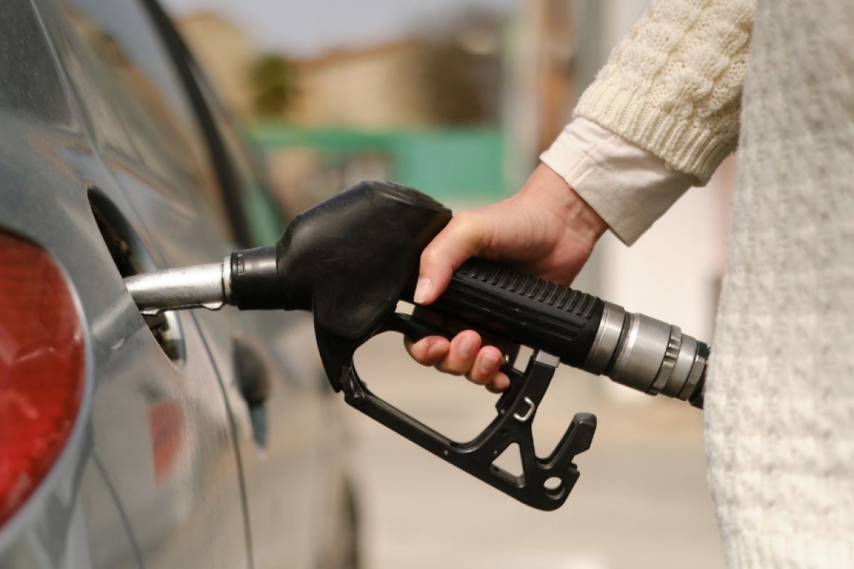 close up of person filling up petrol from bowser