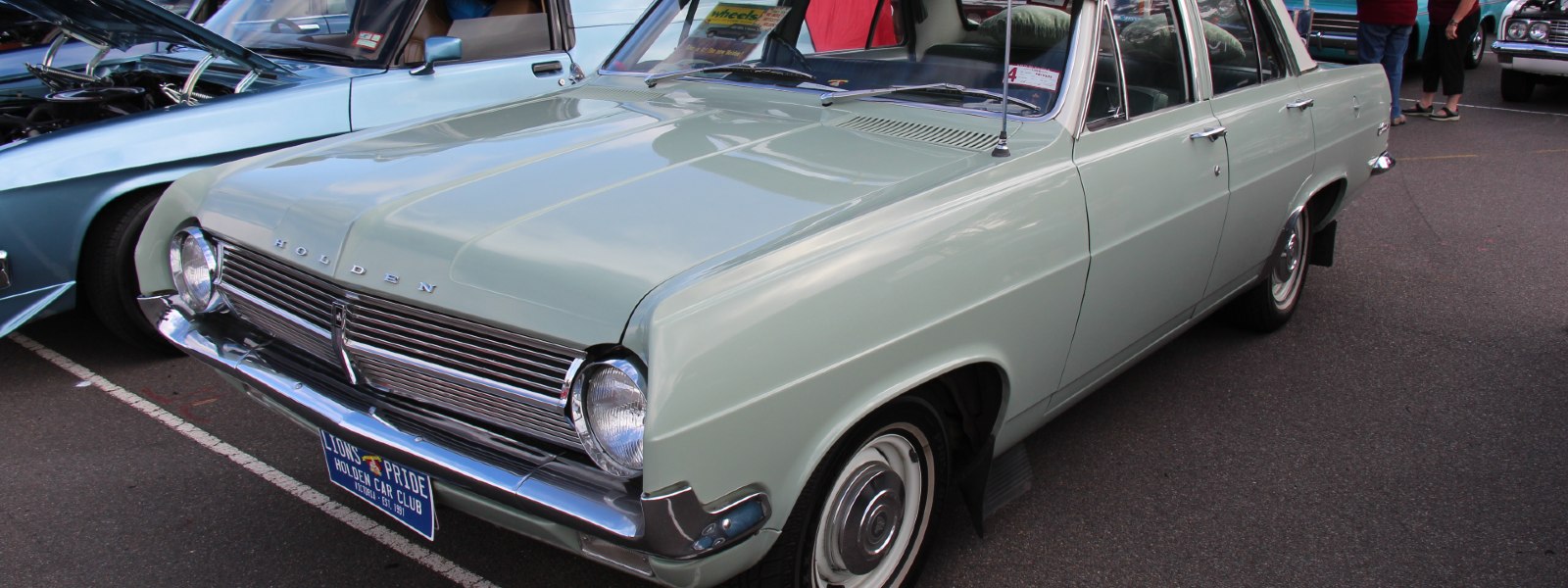 pale hd holden sedan parked in parking lot
