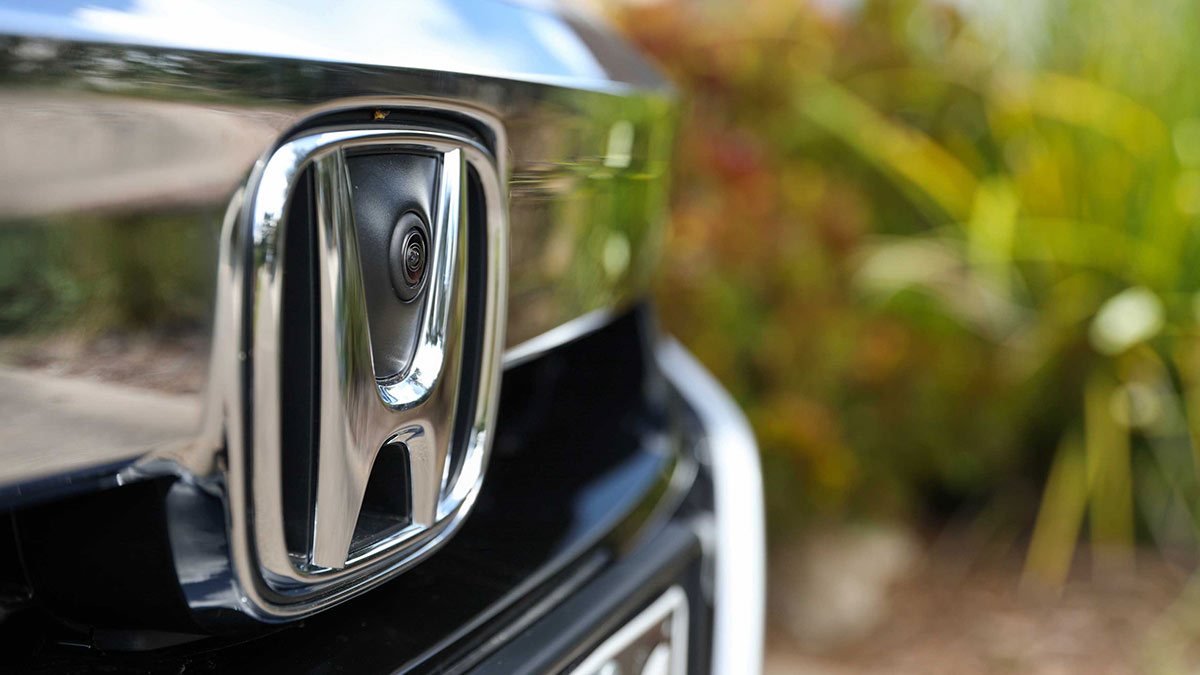 Close up of the front Honda badge and camera of a silver Honda Accord VTi-LX 2020 Hybrid car