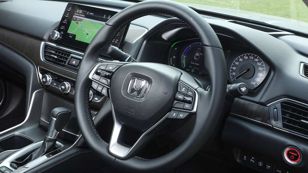 Interior view of a Honda Accord VTi-LX 2020 Hybrid car focusing on the steering wheel and centre console