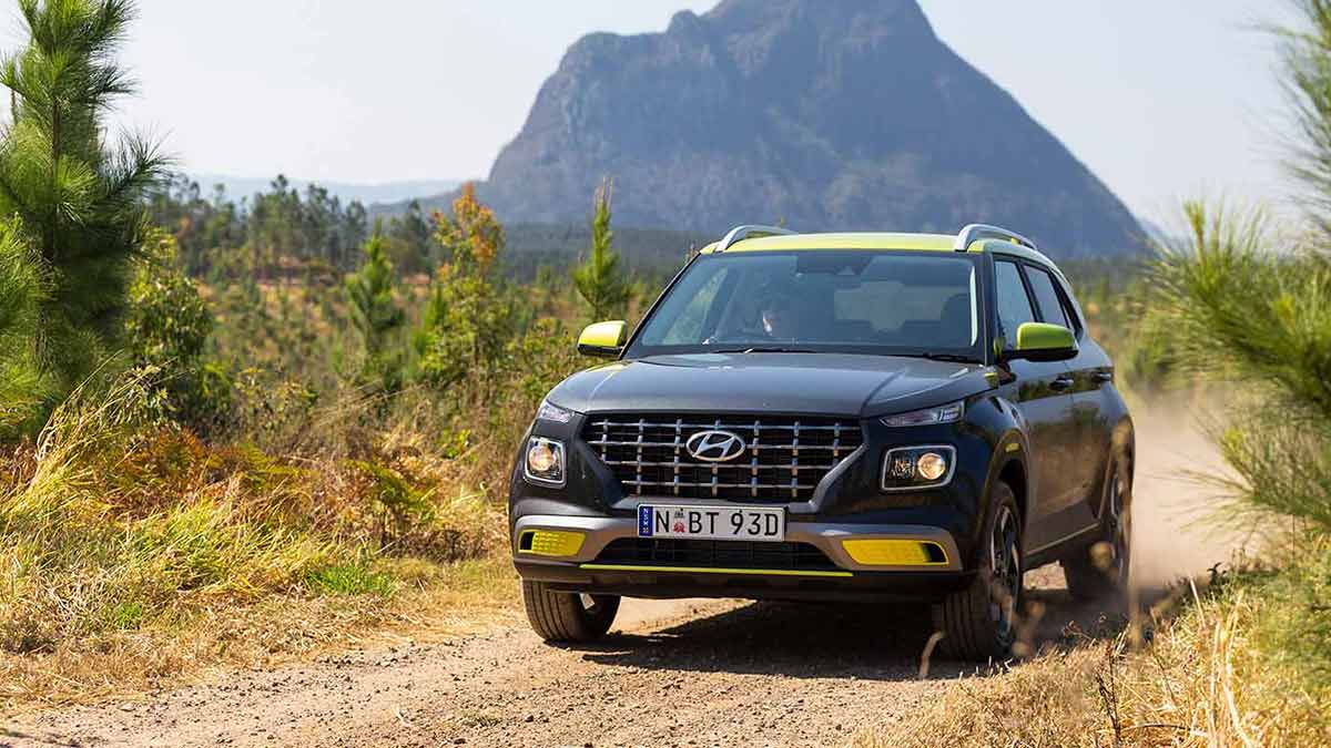 Hyundai Venue with neon detailing driving off road