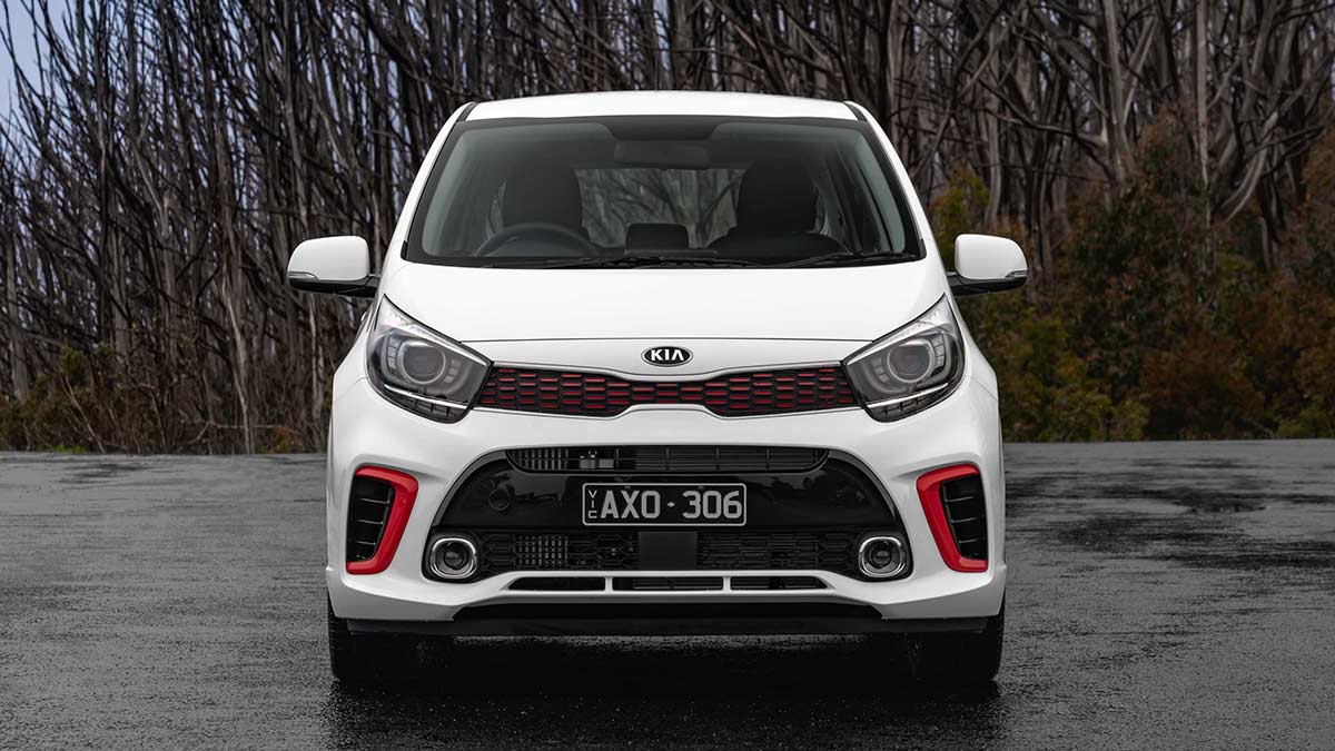 Front view of a white Kia Picanto GT 2019 car parked on a wet tarmac surface