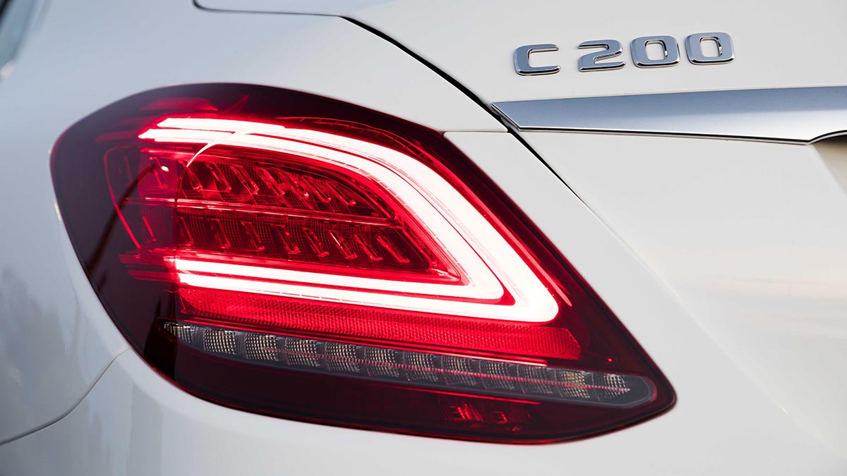 Close up of the tail light and C 200 badge on a white Mercedes-Benz C 200 car