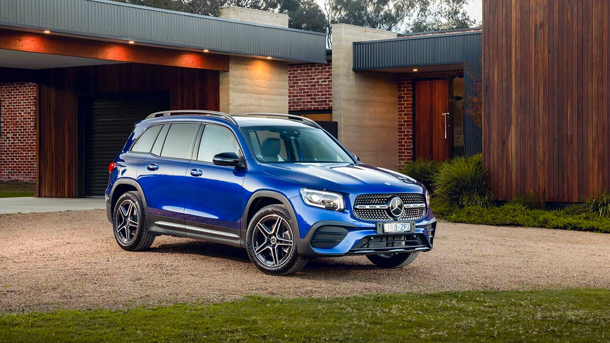 Front side view of a blue Mercedes-Benz GLB250 2020 car parked in a driveway