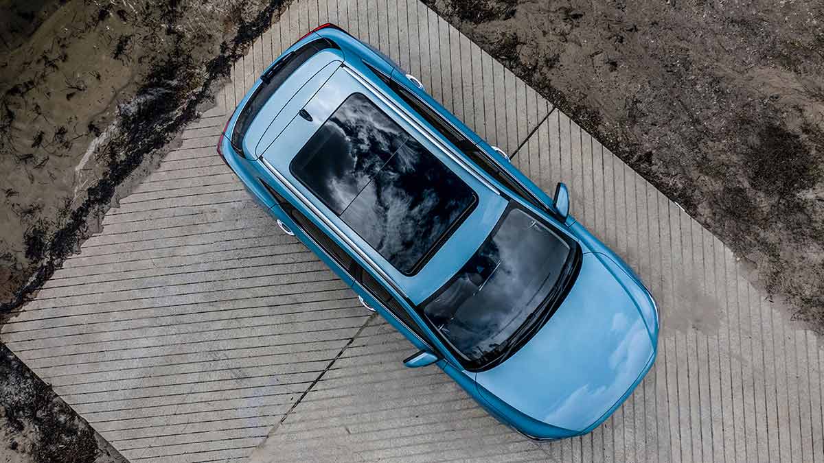 Aerial view of a parked light blue MG ZS electric vehicle